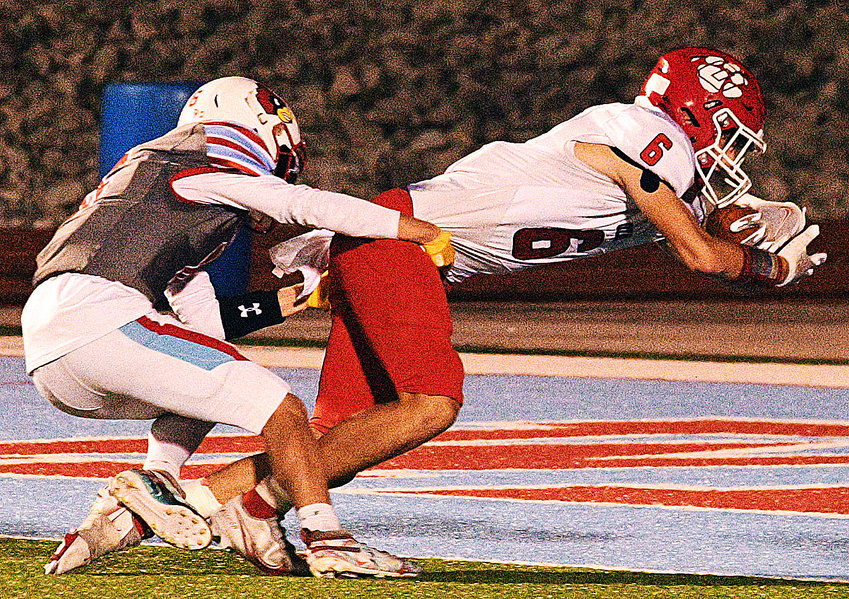 OZARK'S JACE WHATLEY reaches across the end zone for a touchdown at Webb City.