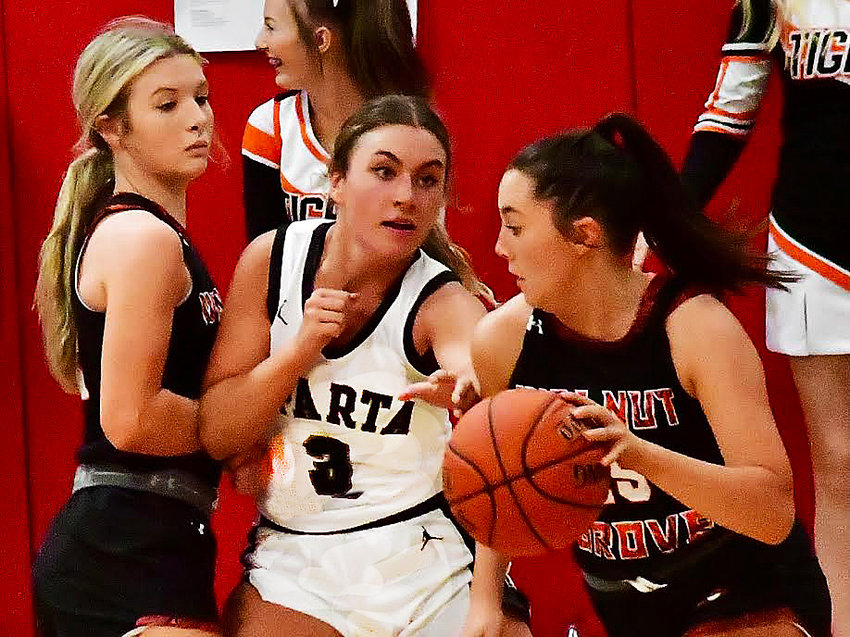 SPARTA'S ASHLYN ROLLER defends in between a pair of Walnut Grove players Friday.