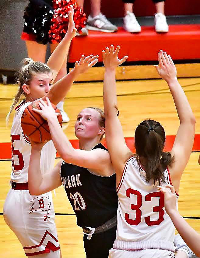 OZARK'S MOLLY RUSHING shoots in between two defenders.