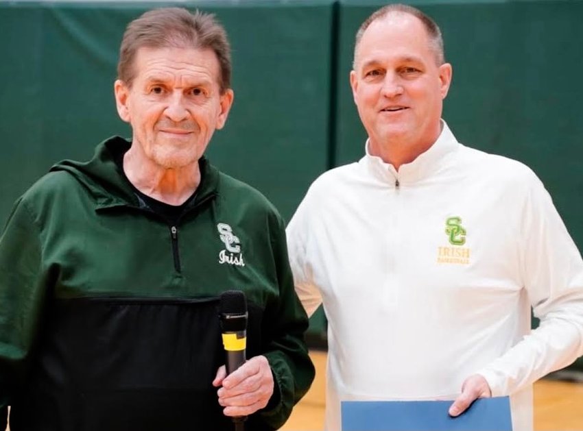 JAY OSBORNE receives his National Federation of High Schools Region Five Coach of The Year certificate while pictured with Springfield Catholic athletics director Dan Evans.