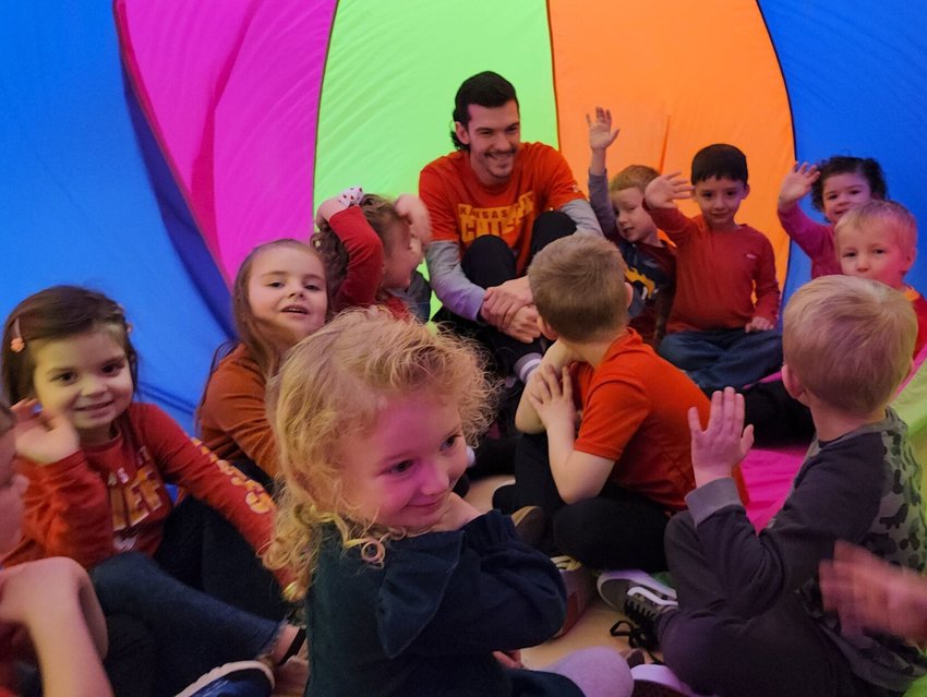 Tiger Paw Early Childhood Center PE Coach Trevor Hale plays with preschoolers during PE class. Preschool screening registration is now open in Ozark. Call 417-582-5992 to schedule an appointment.