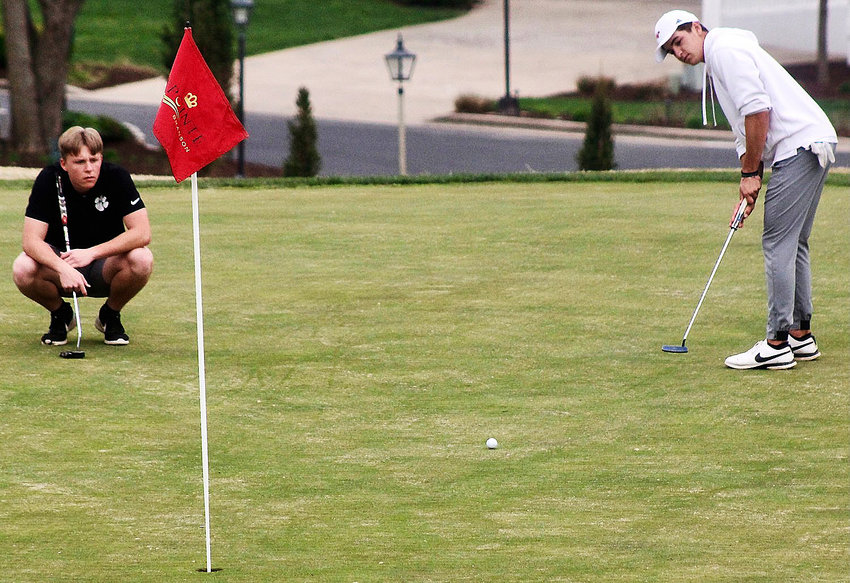 NIXA'S CHANCE WILHITE and Ozark's Seth Palen watch Wilhite's putt roll toward the pin at Pointe Royale Golf Course on Thursday.