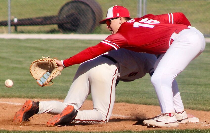 NIXA'S TANNER GRANT tries to reach for an errant pick-off attempt at first base Tuesday against Republic.