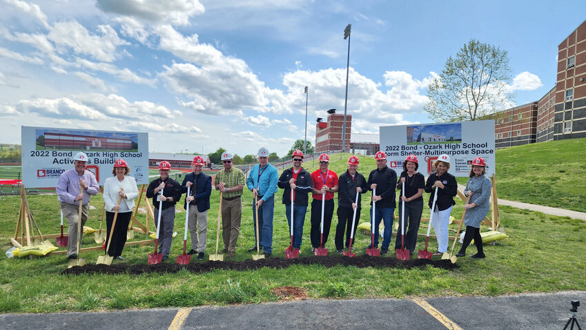 Ozark School District administrators and Board of Education members officially break ground on the Ozark High School storm shelter and indoor activities building on April 21, 2023.