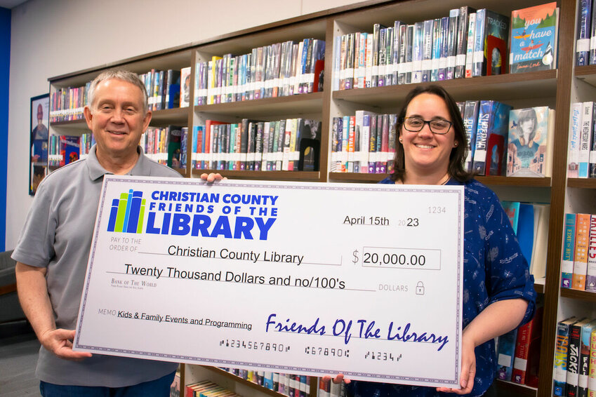 Christian County Friends of the Library President Dave Carmichael presents a $20,000 check to Christian County Library&rsquo;s Executive Director Renee Brumett.
