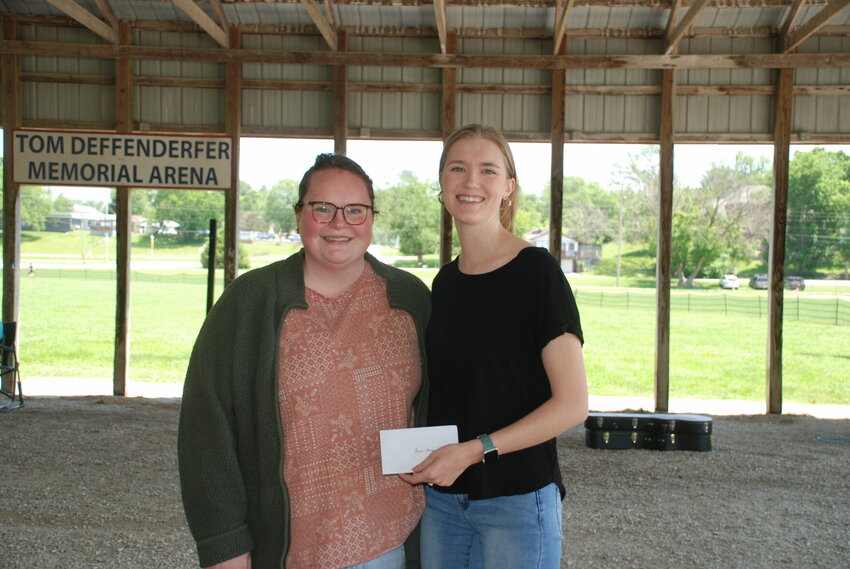 Christian County Agricultural and Mechanical Society President Norrie Bradley (left) presents Grace-Anne Stine with her $750 check.