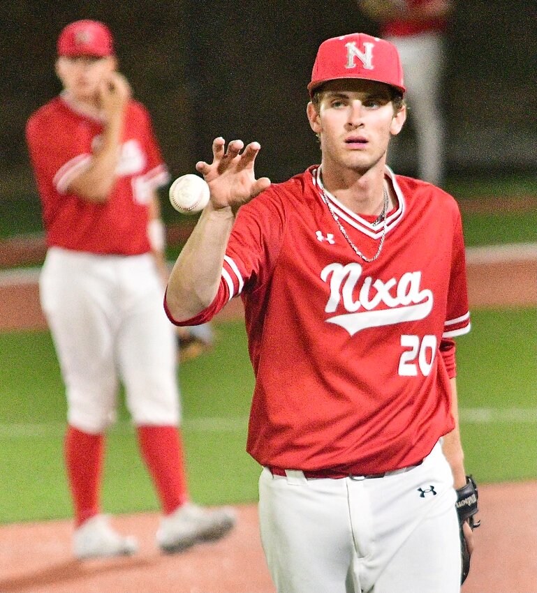 NIXA'S ETHAN TAYLOR receives the ball in between innings at the Class 6 Final Four.