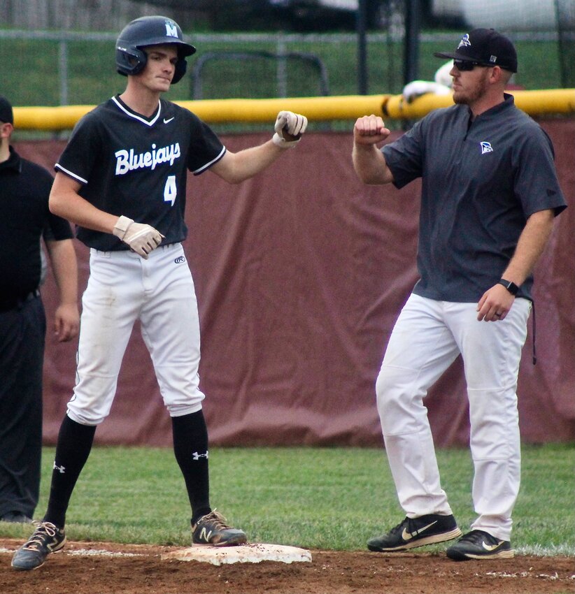 CLEVER'S LANE MENDENHALL receives congrats following a base hit.