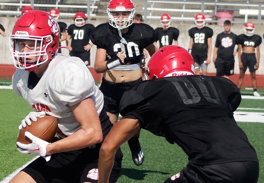 OZARK'S JACE WHATLEY looks for room to run following a reception as a Tigers workout.