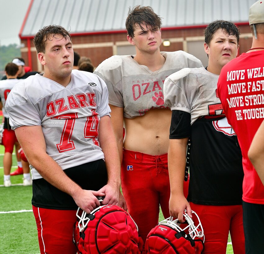 OZARK'S LOGAN SMITH huddles with teammates during the Tigers' summer camp.