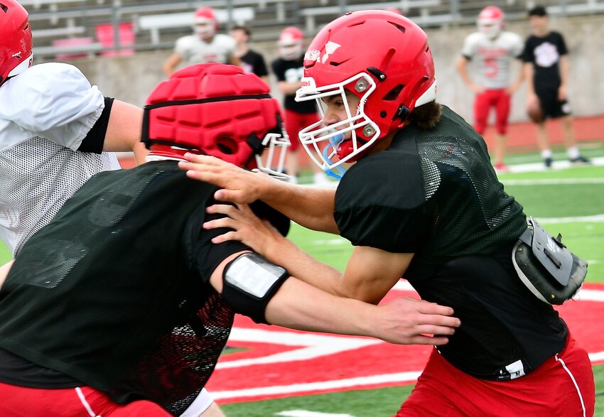 OZARK'S PEYTON BULLINGER works his way past a teammate as part of the Tigers' kickoff coverage during a team camp workout.