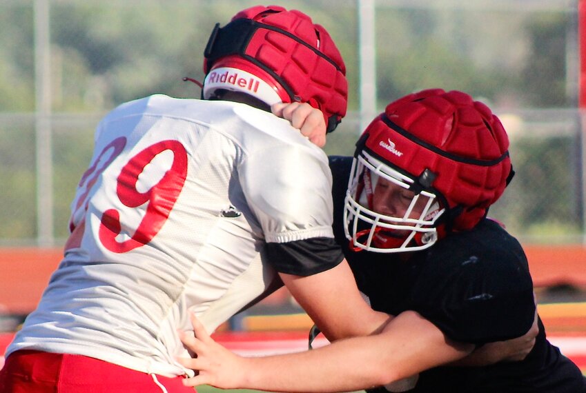 OZARK'S RUBEN ARVIZU battles at the line of scrimmage during a Tigers practice.