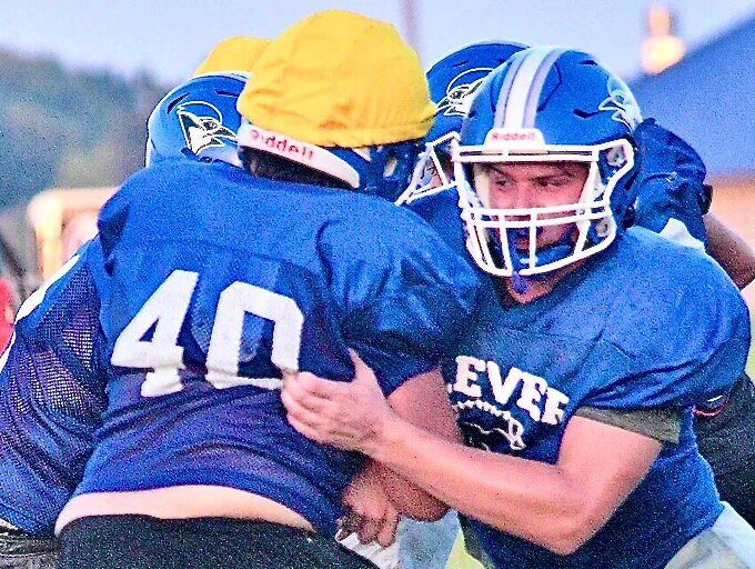 CLEVER'S JACK WHITLINGER fights off a block during a Jays practice.