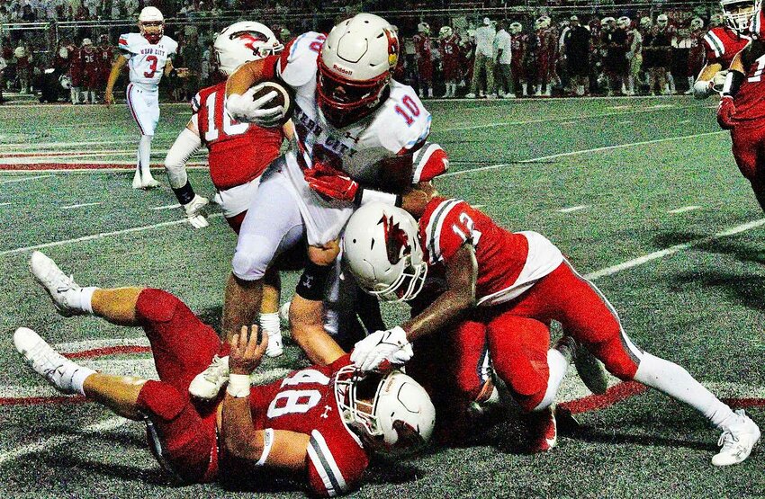 NIXA'S ELI FRAZIER AND BRAYDEN PARKS team up for a tackle versus Webb City on Friday.