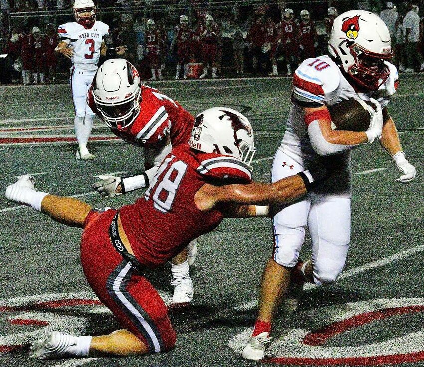 NIXA'S ELI FRAZIER stops a Webb City ball-carrier Friday.