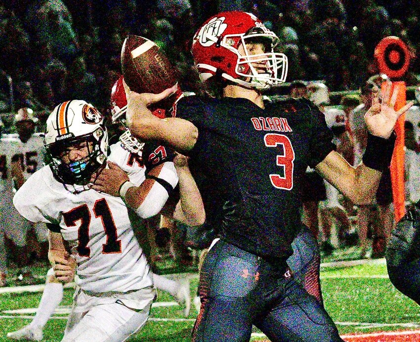 OZARK'S PEYTON RUSSELL drops back to pass against Republic.
