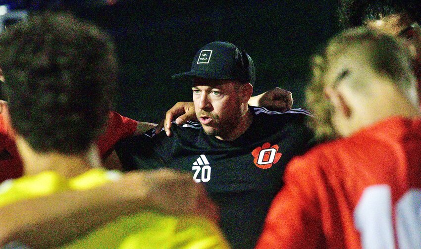 OZARK COACH ZACK OWENS huddles with his players after a recent match.
