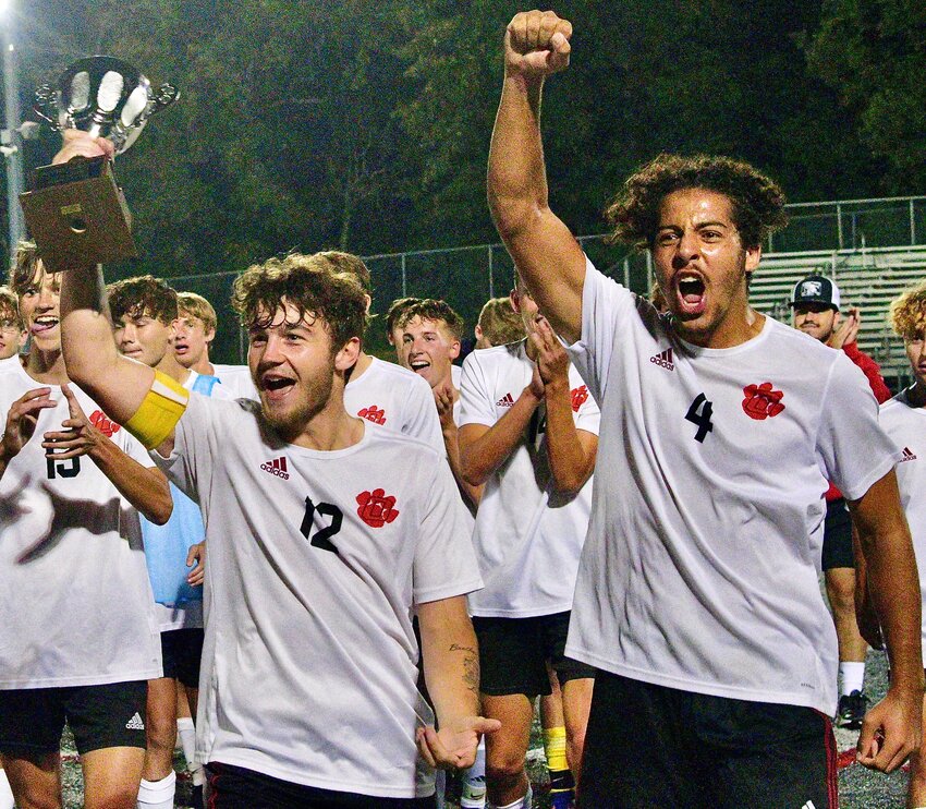 OZARK'S CONNOR CUMMINGS AND ALEX WILLIAMS celebrate the Tigers' 2-0 win at Nixa on Tuesday.