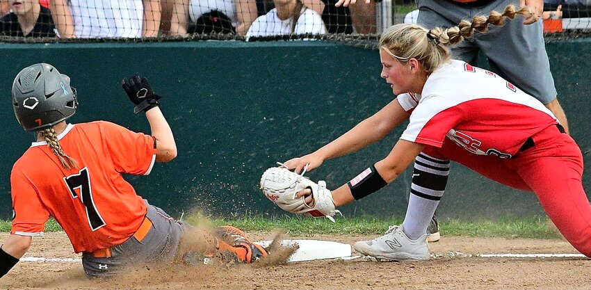 OZARK'S KELSIE BATEY reaches to apply a late tag at third base versus Republic on Tuesday.