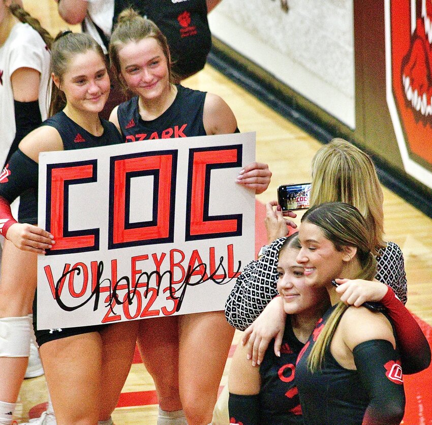 OZARK'S REAGAN BAADE AND JENNA LABARGE are all smiles after the Lady Tigers swept Carl Junction on Friday.