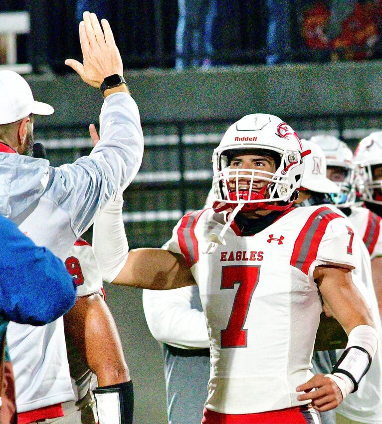 NIXA'S PARKER MANN gets set to exchange a high-five with an assistant coach.