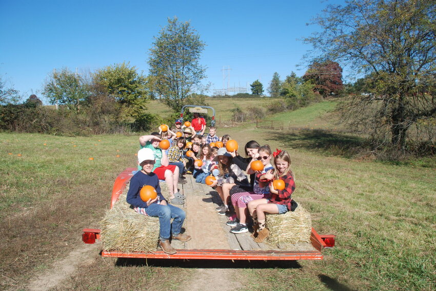 Ozark third graders on a hayride with their pumpkins on Oct. 20.