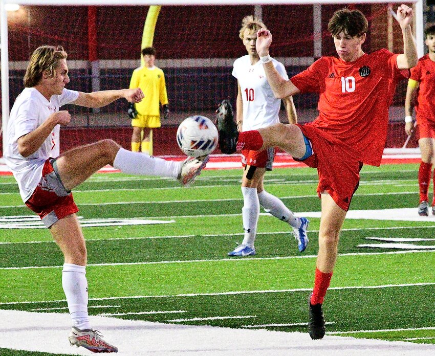 OZARK'S PHIN SCOTT battles for the ball against Nixa during Districts.