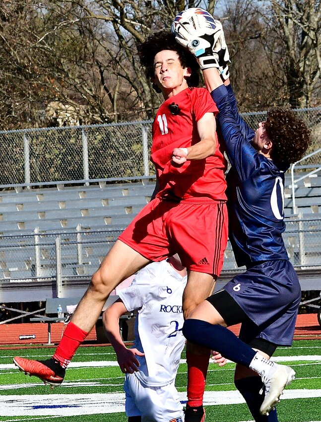 OZARK'S CALEB LEPANT tries to go for a header as Rockhurst's goalie grabs the ball in the teams' match Saturday.