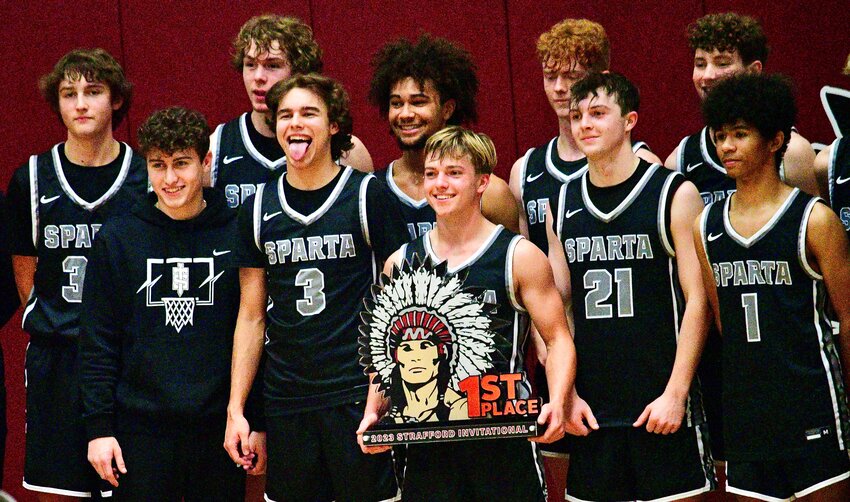 SPARTA PLAYERS pose for photos with the Strafford Tournament championship trophy Saturday.