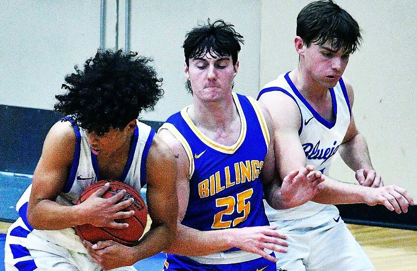 CLEVER'S ELI BUSSARD grabs the ball in front of teammate Lane Mendenhall and Billings' Kameron Clark.