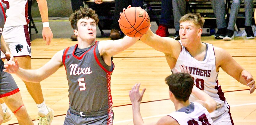 NIXA'S LANE MELTABARGER reaches for a rebound against Mountain Grove at the Blue &amp; Gold Tournament on Wednesday.