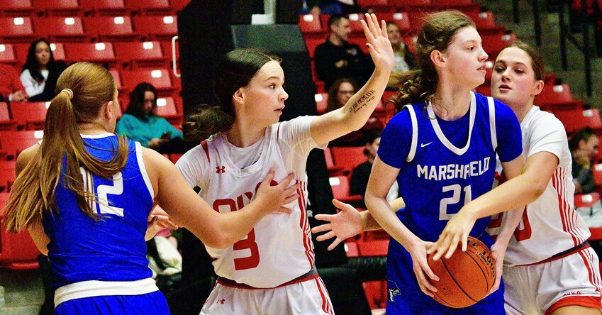 NIXA'S LILY MAHY AND GWEN KUBIK defend against Marshfield players at the Pink &amp; White Tournament on Friday.
