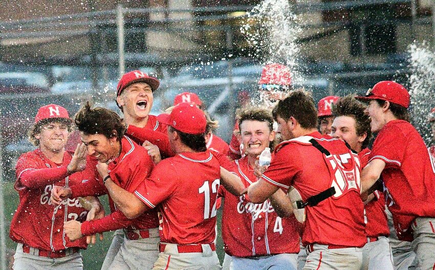 NIXA'S COLIN KELLEY is mobbed by teammates during the Eagles' Class 6 District 5 championship celebration.