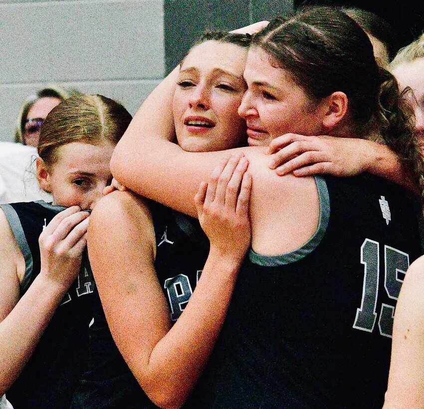 SPARTA'S LIVI LOVELAND AND AMREE YOUNGMON share a hug during the Lady Trojans' celebration Saturday.