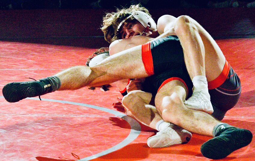 NIXA'S REED WILSON establishes control of Ozark's Talyn VanHorn in their match at 138 pounds Thursday.