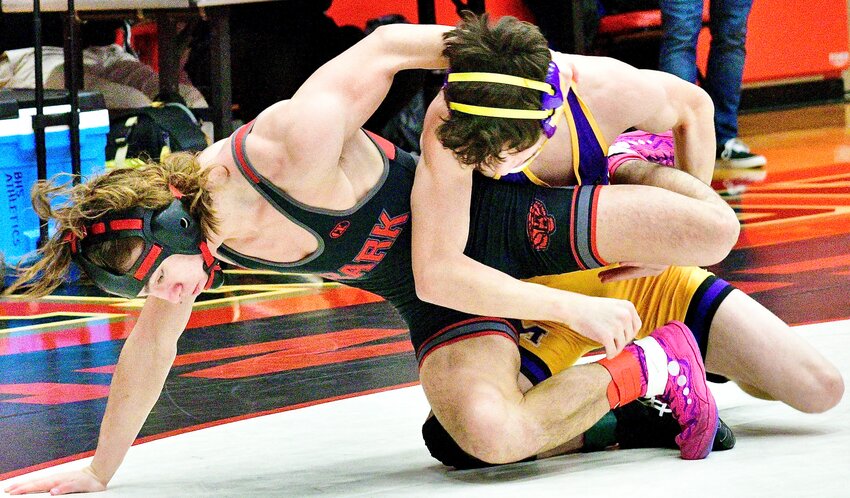 OZARK'S DAMIEN MOSELEY looks to escape from Monett's Simon Hartline at the Branson Tournament on Saturday.