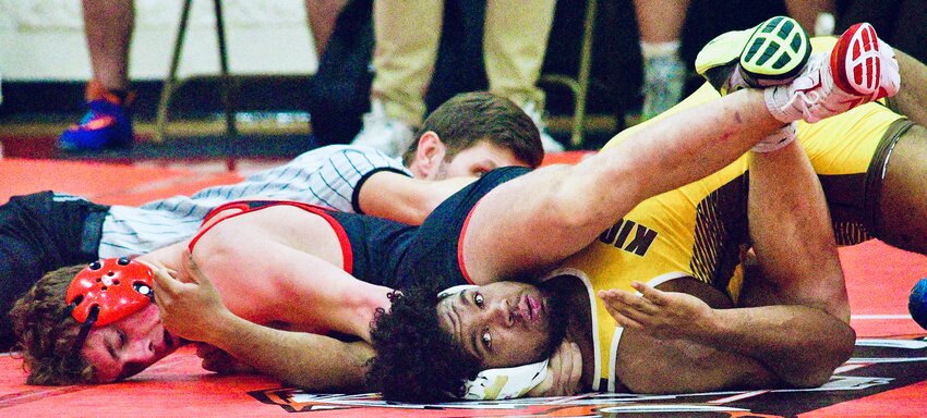 OZARK'S JOHNNY WILLIAMS closes in on a pin in the Tigers' dual with Kickapoo on Tuesday.