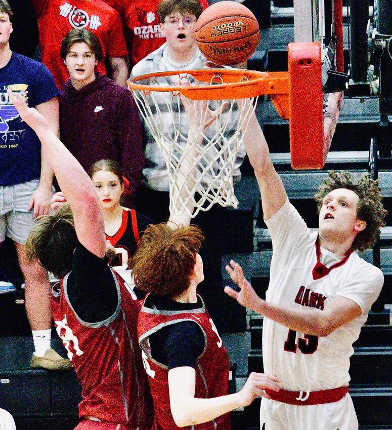 OZARK'S MANNY STOVER closes at the rim Tuesday.