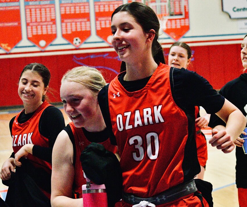 OZARK'S  AVERY HAVENS, right, celebrates the Lady Tigers; win at Glendale on Wednesday with teammates Kori Roussell and Lauren Carson.