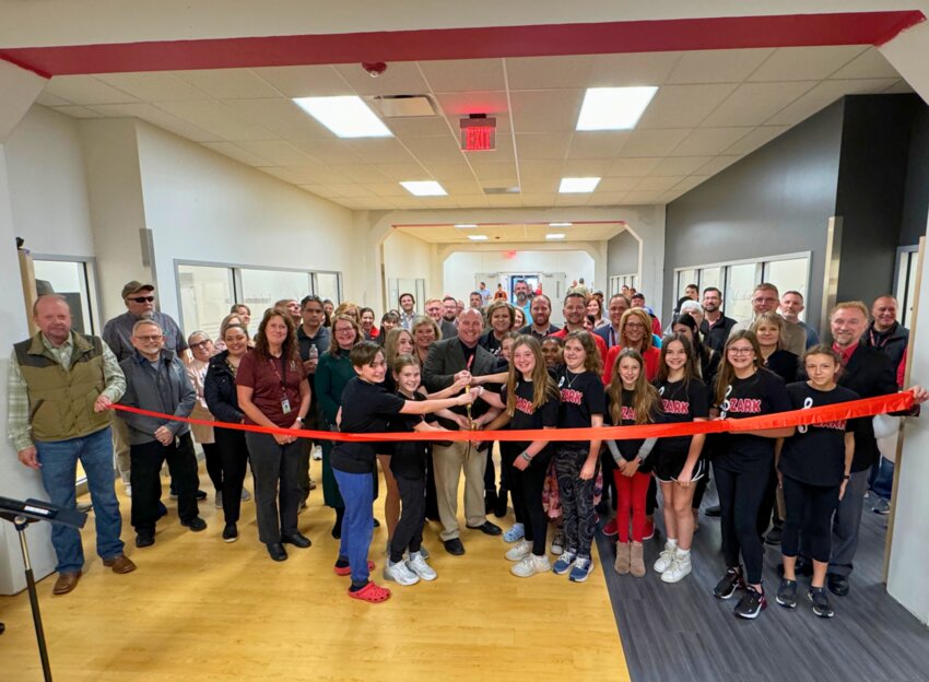 Ozark staff, students and community members cut the ribbon for Ozark Middle School's new storm shelter.
