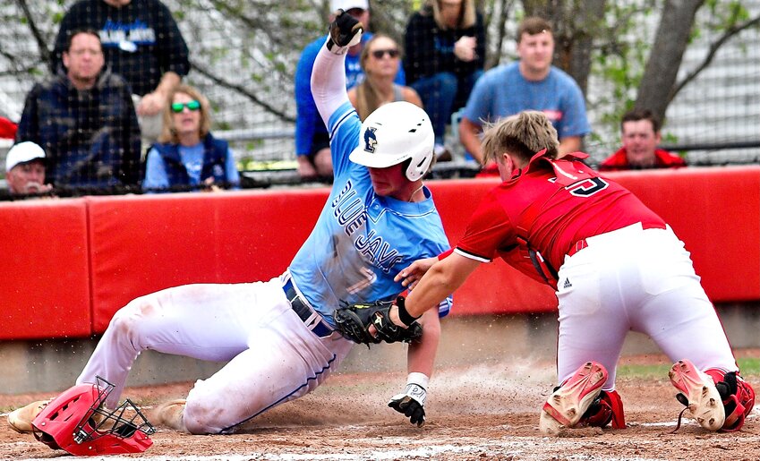 OZARK'S GANNON MILLER tags out a Liberty baserunner at home plate in the teams' contest Saturday.