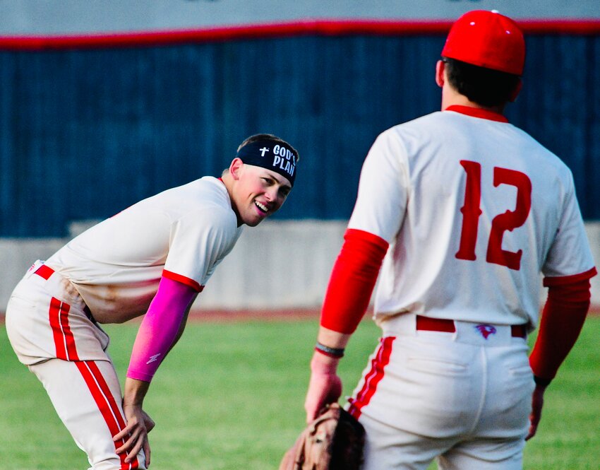NIXA'S CAEDEN CLOUD smiles while chatting with teammate Broden Mabe in between innings.