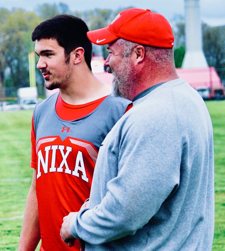 NIXA'S JACKSON CANTWELL, left, chats with his father, Christian, during the Nixa Invitational last week.
