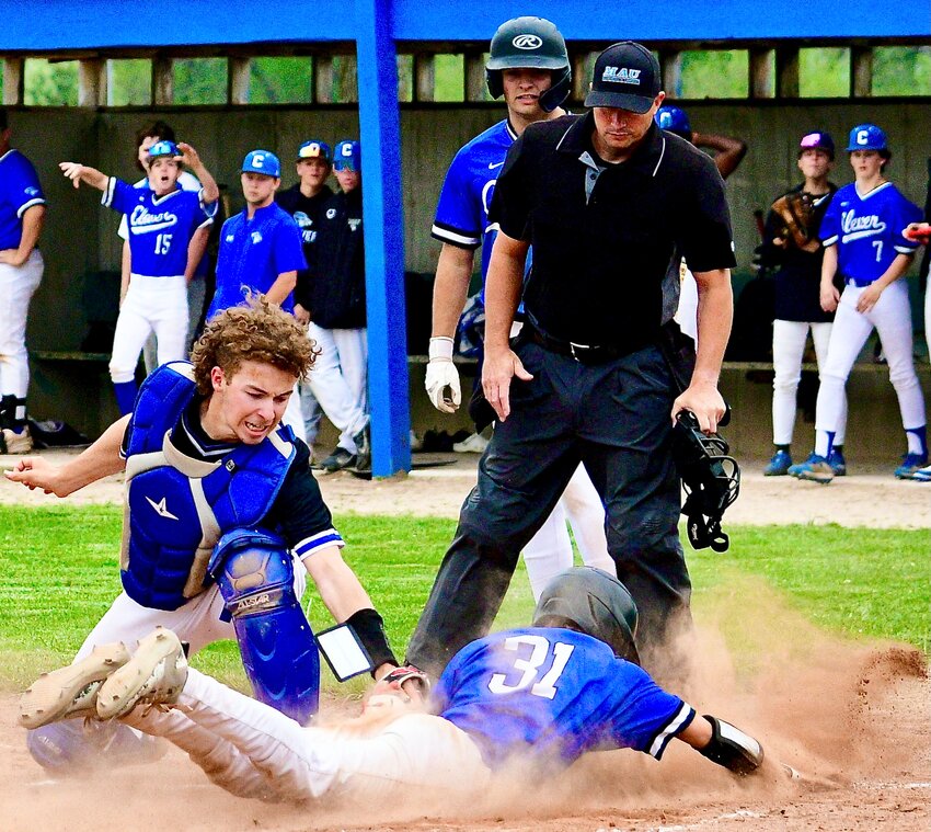 CLEVER'S JACOB EDGE beats the tag of Greenwood's catcher  at home plate Thursday.