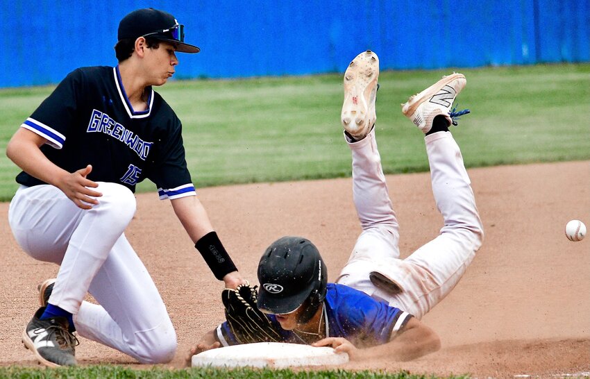 CLEVER'S TYSYN CLARK slides safely onto third base.