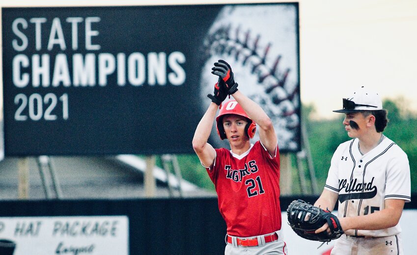 OZARK'S ALEX NIMMO signals to his teammates after hitting a double.