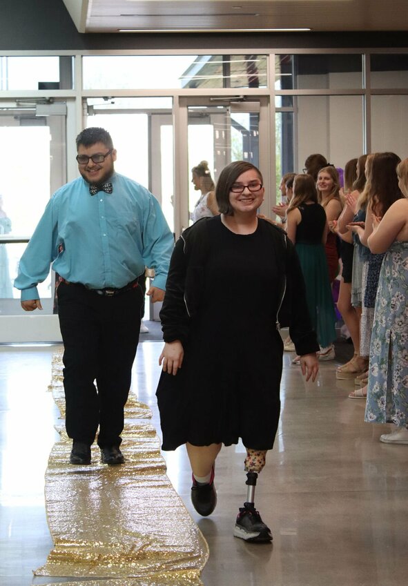 Students walk the gold carpet to the cheers of students and staff.