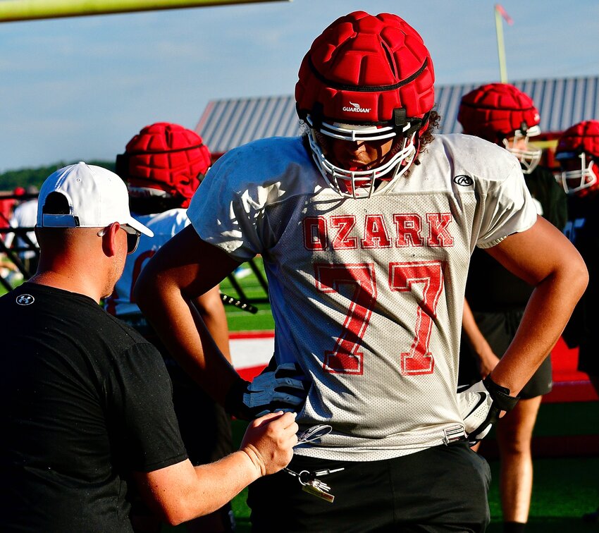 OZARK'S JAYDEN WASHINGTON listens to instructions from Tigers offensive line coach Jacob Gideon.