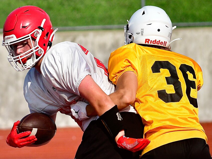 OZARK'S LAINE EMMERTH carries the ball during a practice with Kickapoo.