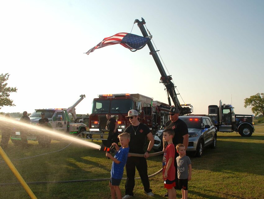 Kids put their strength to the test by spraying water from the firehose at Sparta's National Night Out on Aug. 6, 2024.
